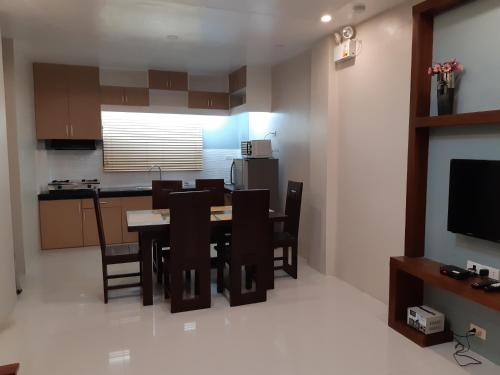 a kitchen and dining room with a table and chairs at Restful 3BR Hillside Duplex House in Baguio