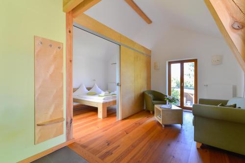 a living room with a sliding glass door leading to a bedroom at Dreigärten Brodowin in Brodowin