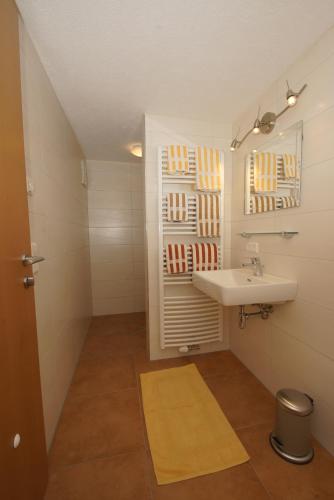 a small bathroom with a sink and a mirror at Haus Tauernseitn in Schladming