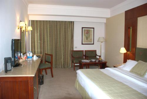a hotel room with a bed and a desk at Safir Hotel Cairo in Cairo