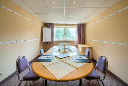 a conference room with a wooden table and chairs at Best Western Hotel Jena in Jena