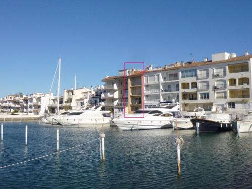 a group of boats docked in a marina with buildings at Apart-rent Apartment Port Salins 0155 in Empuriabrava