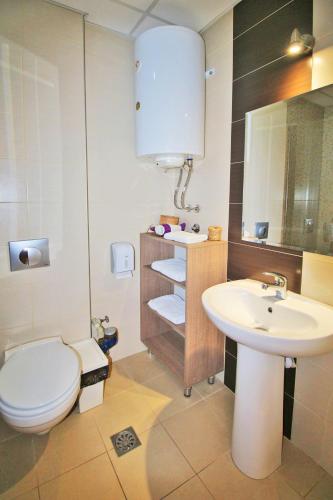 a bathroom with a white toilet and a sink at Luxury Skopje Apartments Premium in Skopje