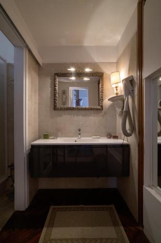 a bathroom with a large sink and a mirror at Ca' della Corte in Venice
