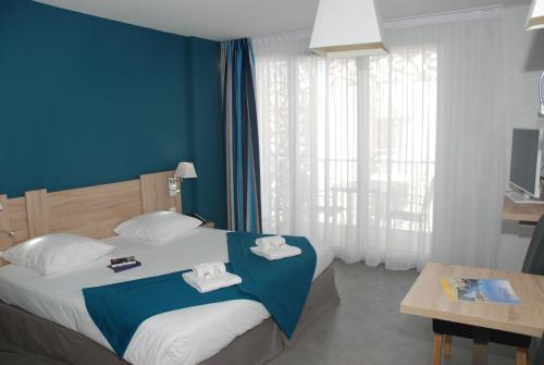 Katil atau katil-katil dalam bilik di Appart'Hotel Odalys Nakâra