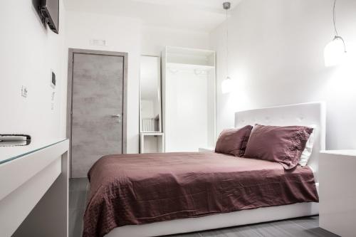 Postel nebo postele na pokoji v ubytování Pomodoro Bed