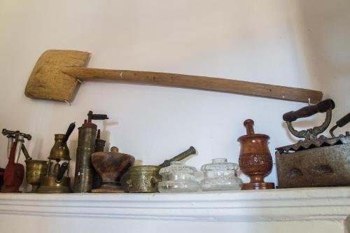 a shelf with many different types of bottles on it at The Scarlet House in Meyisti