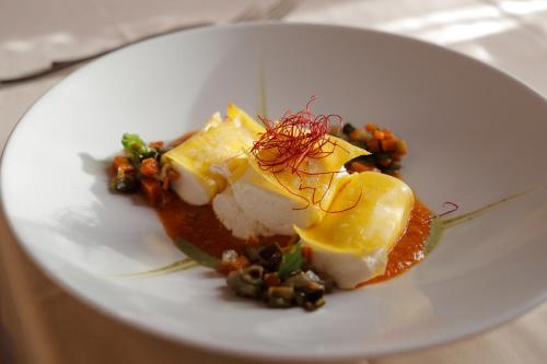 a white plate of food on a table at Hotel Palazzo San Lorenzo & Spa in Colle Val D'Elsa