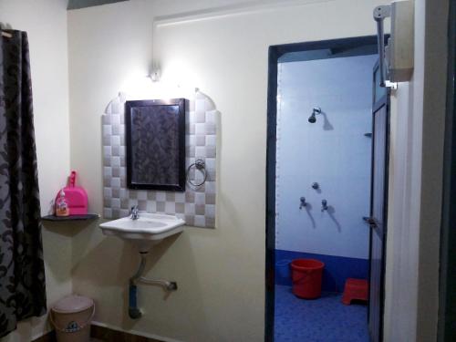 a bathroom with a sink and a shower at Hotel Rosary House in Malvan