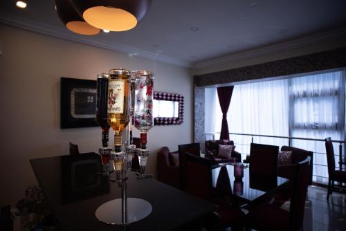 a dining room with a table and a chandelier at The Ritzz Exclusive Guest House in Accra