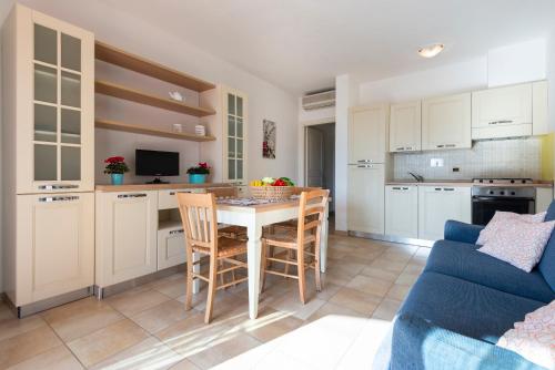 a kitchen and living room with a table and chairs at Aba Village RTA in Puntone di Scarlino