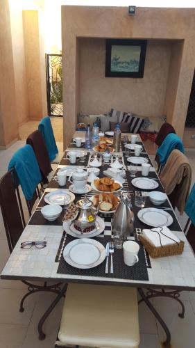 una mesa larga con platos de comida. en Villa Firdaous, en Marrakech