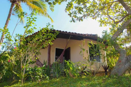 a small house in the middle of some trees at Pousada Colibri in Morro de São Paulo