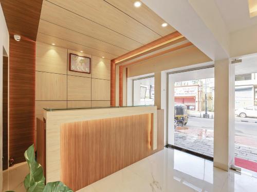 a pivot door in a room with a wall at Treebo Goodland Residency - 500m from Railway Station in Trivandrum