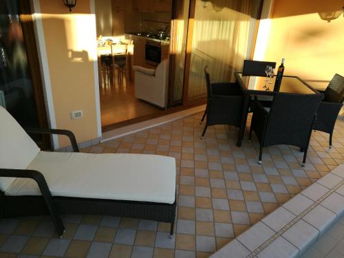 a living room with a table and chairs at Residence Eleonora in Sottomarina
