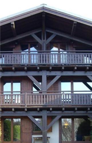 a wooden balcony on the side of a building at La Résidence de L'Ours in Megève