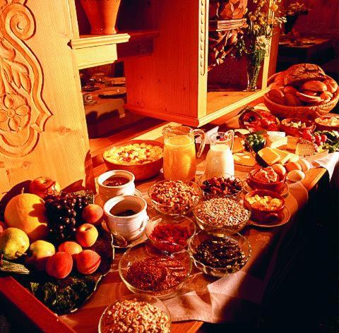 a table topped with lots of different types of food at Sporthotel Krone in Schoppernau