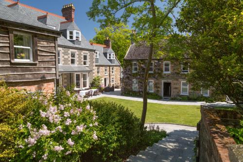 a garden in front of a house at Stocks Hotel in Sark