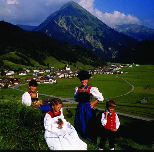 a group of children in traditional clothing standing on a mountain at Sporthotel Krone in Schoppernau