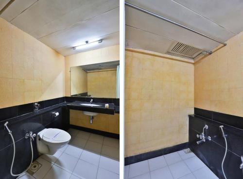 a bathroom with a toilet and a sink at Hotel President Inn By Sky Stays in Gandhinagar