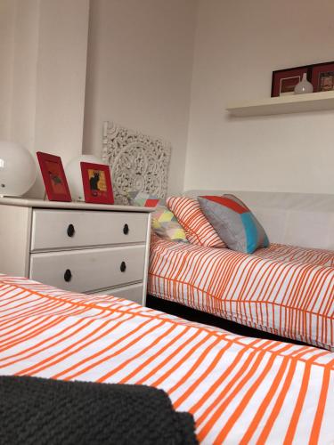 a bedroom with two beds and a dresser at Lagunilla Rural in Fuente de Piedra