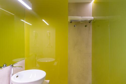 a bathroom with a sink and a toilet and a shower at Hotel Macià Sevilla Kubb in Seville