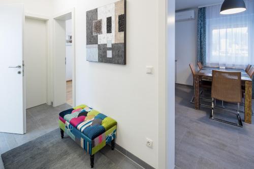 a living room with a chair and a table at Design-Apartments Graz in Graz