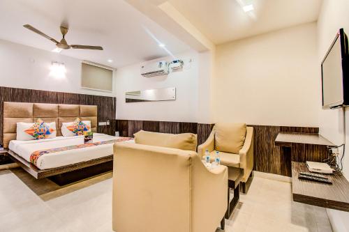 a bedroom with a bed and a desk at Capital Suites in Bengaluru