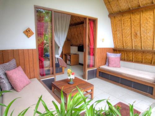 a living room with a couch and a table at Chill Out Bungalows in Gili Islands