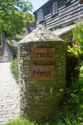 a stone wall with a sign that reads shocks hotel at Stocks Hotel in Sark