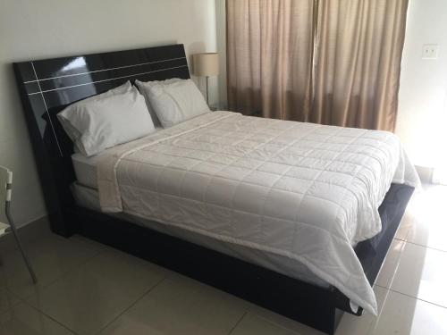 a bedroom with a large bed with white sheets and pillows at Pelican By The Sea in Pompano Beach