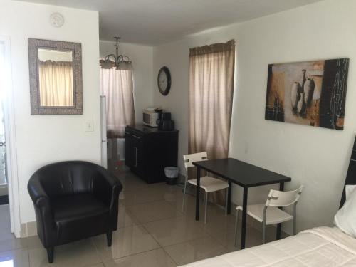 a bedroom with a table and a chair and a bed at Pelican By The Sea in Pompano Beach