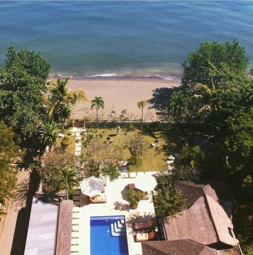 a view of the beach from the balcony of a resort at Frangipani Beach Hotel in Lovina