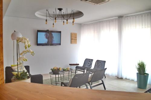 a living room with chairs and a table at Ouril Hotel Julia in Santa Maria