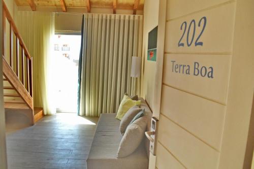 a room with a bed with a sign on the wall at Ouril Hotel Julia in Santa Maria