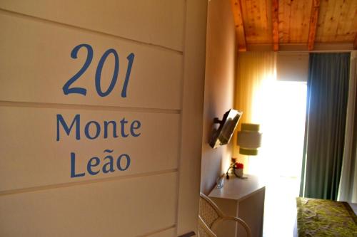 a sign on a wall in a room with a bed at Ouril Hotel Julia in Santa Maria
