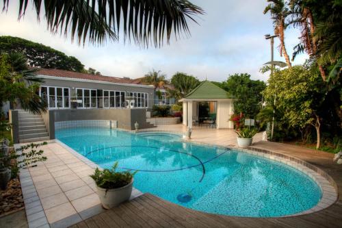 a swimming pool in the middle of a yard at 39 on Church in Port Elizabeth