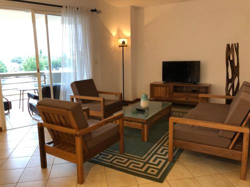 a living room with a couch and a tv at Center Point in Diego Suarez