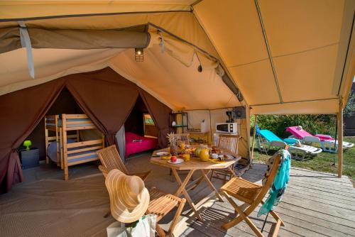een tent met een tafel en stoelen erin bij Camping des Alberes in Laroque-des-Albères