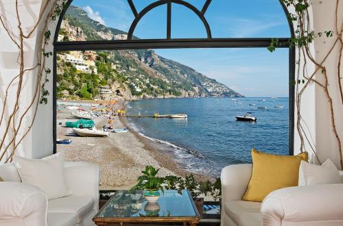 a room with a view of a beach and the ocean at Covo Dei Saraceni in Positano