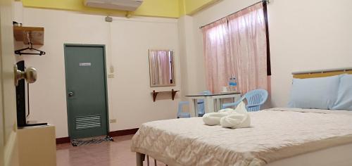 a bedroom with a bed with two white bowls on it at DD Mansion in Ban Talat Rangsit