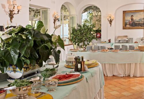 a buffet line with plates of food and plants at Covo Dei Saraceni in Positano