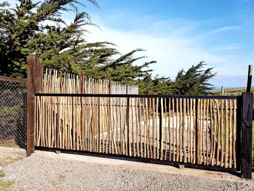 a wooden fence in front of a beach at Tiny Apartment Las Puyas Ocean View in Boca Pupuya