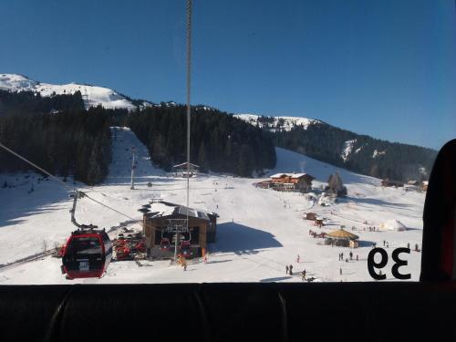 a ski slope with a ski lodge and a ski lift at Berghaus Koglmoos in Auffach