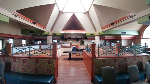 a restaurant with a bar with chairs and tables at Travelodge Hotel by Wyndham Vancouver Airport in Richmond