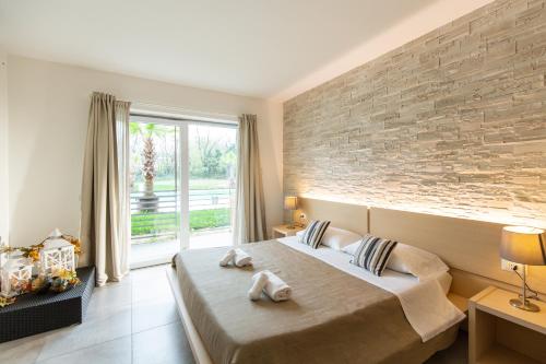 - une chambre avec un grand lit et un mur en briques dans l'établissement Agriturismo Dolce Luna, à Milan