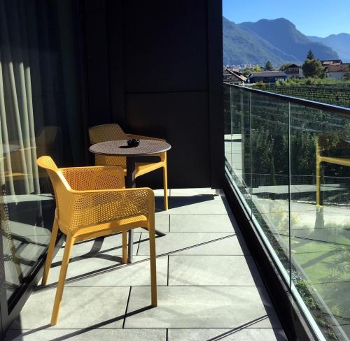 a balcony with a table and chairs on it at Hotel Raffl in Bolzano
