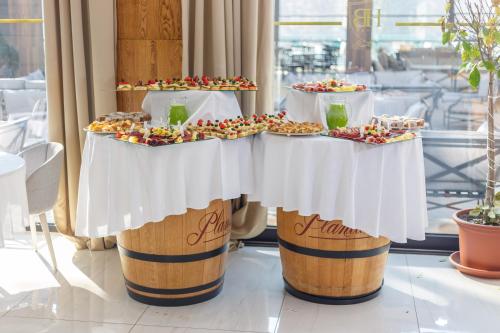 a buffet of food on top of wine barrel barrels at Hotel Berane in Berane