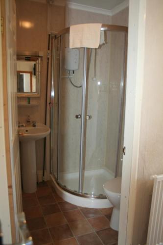 a bathroom with a shower and a sink at The Haldon Guest House in Paignton