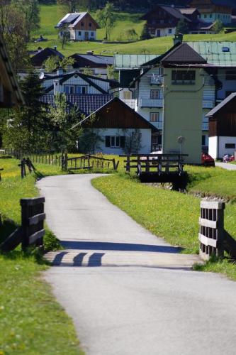 a winding road in a village with houses at Loetje in Gosau